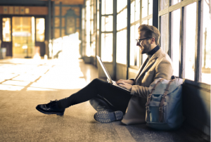 a person using a laptop on the floor
